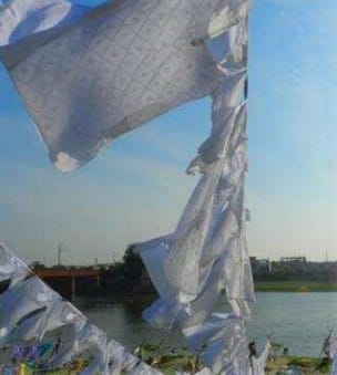 Chikankari fabric being washed and bleached to remove block print outlines, revealing the intricate embroidery.